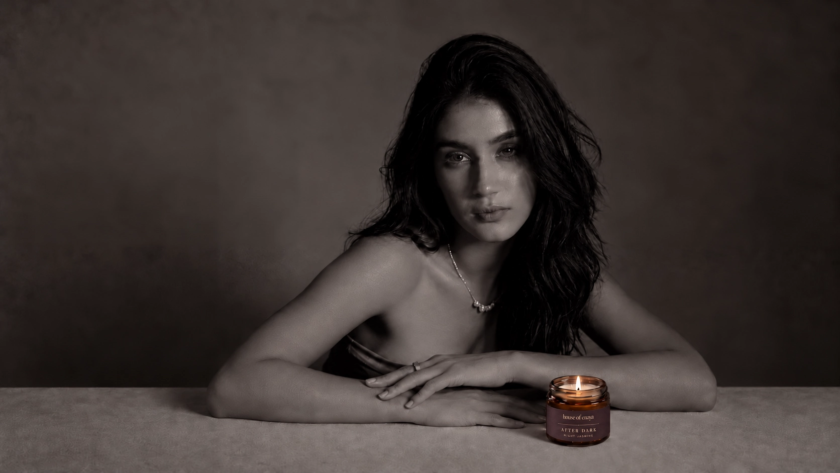 Enaya with the small AFTER DARK candle in a monochrome portrait